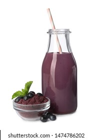 Glass Bottle Of Acai Drink With Berries And Powder On White Background