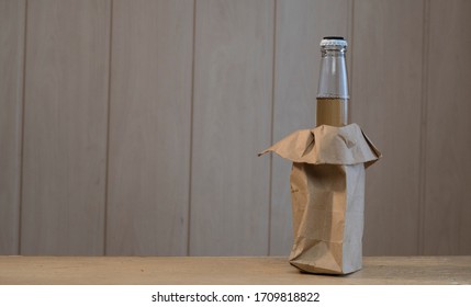 Glass Bottle With Beer In A Paper Bag With Copy Space