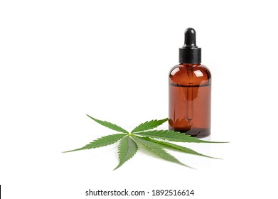 Glass Bottle With CBD Oil And Cannabis Leaves Isolated On White Background.