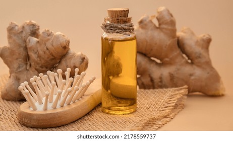 Glass Bottle Of Essential Ginger Oil, Ginger Root On Beige Background. Healthy Alternative Living. Natural Cosmetics Ingredients For Hair Care. Earth Tones Wellness Eco Comb Homemade Hair Mask Beauty 