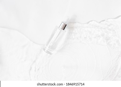 Glass Bottle With Fluid Collagen And Hyaluronic Acid, Hydration Skin. Top Flatlay View Copyspace. Abstract Water Background.