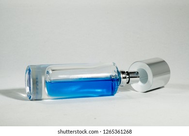 Glass Bottle With Half Full Blue Solution Lay Down And Open Cap 