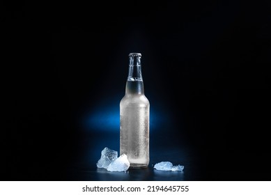 Glass Bottle With A Hard Seltzer Drink On A Black Background. Bottle Without Label