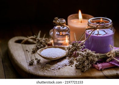 Glass Bottle Lavender Essential Oil Dried Seed  Aromatherapy Spa Massage Concept. Herb Purple Candle Wood Table Background Sea Salt Still Life Rustic Cutting Board Napkin.