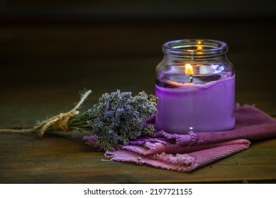 Glass Bottle Lavender Essential Oil Dried Seed  Aromatherapy Spa Massage Concept. Herb Purple Candle Wood Table Background Sea Salt Still Life Rustic Cutting Board Napkin.