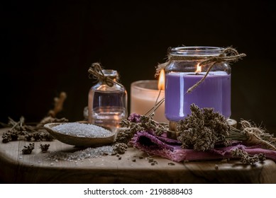 Glass Bottle Lavender Essential Oil Dried Seed  Aromatherapy Spa Massage Concept. Herb Purple Candle Wood Table Background Sea Salt Still Life Rustic Cutting Board Napkin.