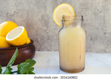 Glass Bottle With Lemon Slush And A Lemon Slice