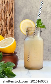 Glass Bottle With Lemon Slush And A Lemon Slice