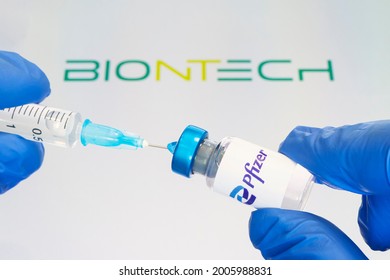 Glass bottle with logo Pfizer and BioNTech, American multinational pharmaceutical company. January 18, 2021, Barnaul, Russia.