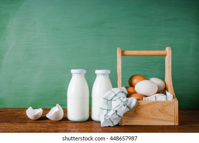 Glass bottle with milk and eggs on green background. - Shutterstock ID 448657987