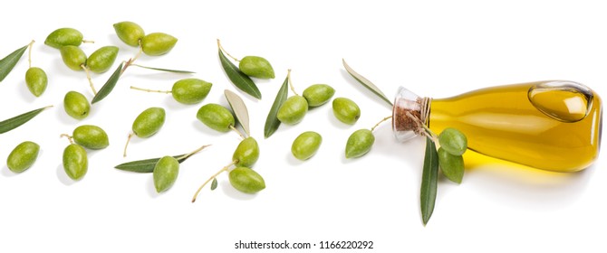  Glass bottle with olive oil and green olives with leaves isolated on white background.