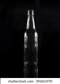 A Glass Bottle On Black Background.