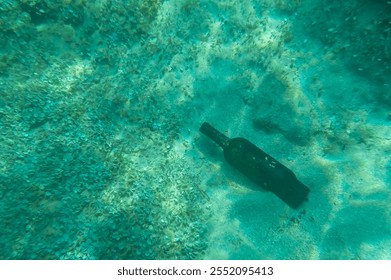 Glass bottle on a sandy seabed. Underwater photography in Otranto, Italy. - Powered by Shutterstock