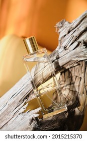 Glass Bottle Of Perfume On A Driftwood, Natural Shade Background, Perfume With Woody Notes