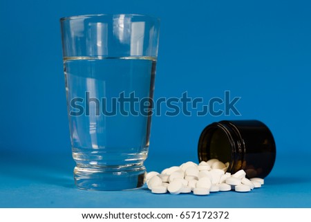 Glass bottle for pills. Beautiful blue background.