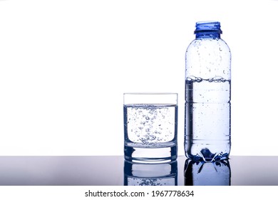 Glass And Bottle Of Pure Water Isolated On White Background. Drinking Water,Health Benefits