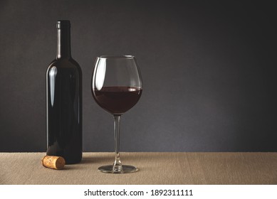 Glass And Bottle Of Red Wine On A Table