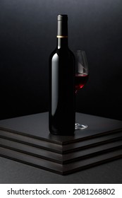 Glass And Bottle Of Red Wine On A Dark Background. 