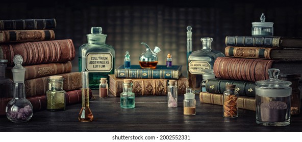 Glass Bottles, Old Books On Table Of A Scientist. Medicine, Chemistry, Pharmacy, Apothecary, Alchemy History Background. Translation From Labels-eyewash Astringent, Morphine Hydrochloride And Almonds.