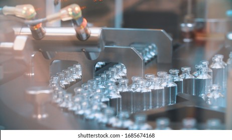 Glass bottles in production in the tray of an automatic liquid dispenser, a line for filling medicines against bacteria and viruses, antibiotics and vaccines. - Powered by Shutterstock