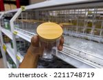 Glass bottles with wooden lids in general supply stores.