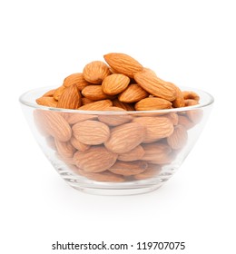 Glass bowl with almonds isolated on white background