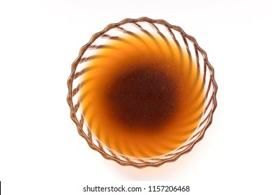 Glass Bowl Of Beef Broth With Steam Isolated On White Background. Overhead Shot