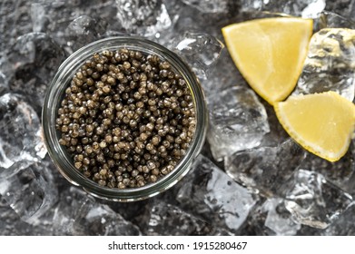 Glass bowl of black caviar with crushed ice