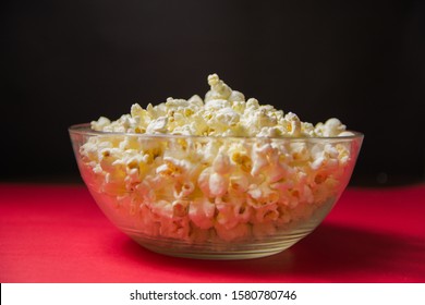 Glass Bowl Full Of Fresh Hot Popcorn On Red And Black Background Film Movie Cinema Home Theater Theme Background