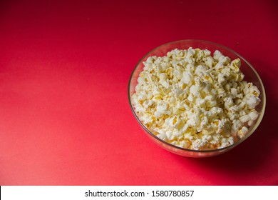 Glass Bowl Full Of Fresh Hot Popcorn On Red Background Film Movie Cinema Home Theater Theme Background