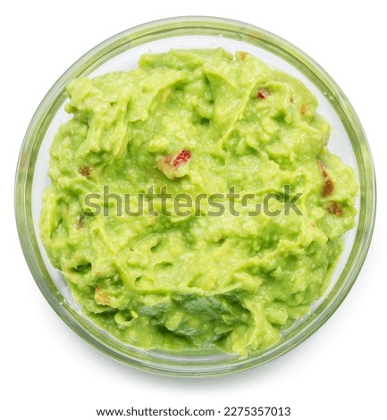 Glass bowl of guacamole on white background. Top view. File contains clipping path.