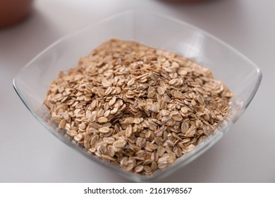 Glass Bowl Of Oat Flakes On White Kitchen Counter