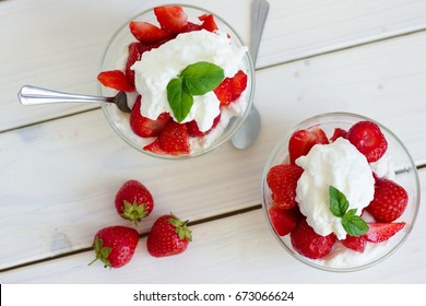 Glass bowl of strawberries with whipped cream. Traditional snack at famous lawn tennis tournament.