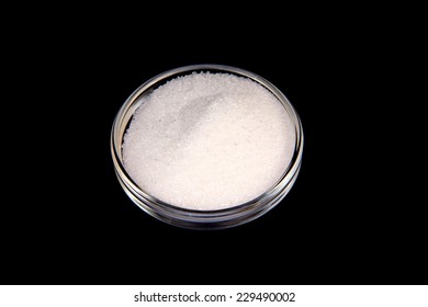 Glass Bowl With Sugar On A Black Background