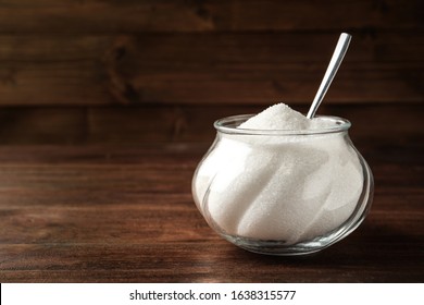 Glass Bowl With Sugar And Spoon On Wooden Table. Space For Text