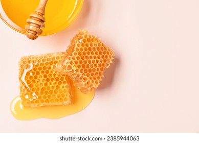 Glass bowl with sweet honey and combs on pink background - Powered by Shutterstock