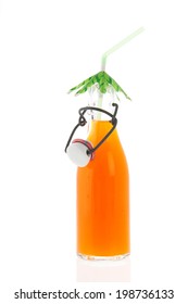 Glass bracket bottle with orange soft drink and tropical drinking straw isolated over white background