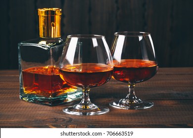 Glass of brandy or cognac on the wooden table