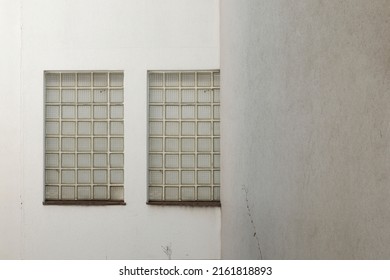 Glass Brick Windows In A White Stone Wall,
No Person, Space For Text