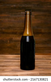 Glass Brown Bottle Of Beer,ale With Foam,foap On Wooden Table, Background Close Up. Alcohol Cocktail, Bar Drink, Booze Party Concept.mockup, Template, Copy Space.