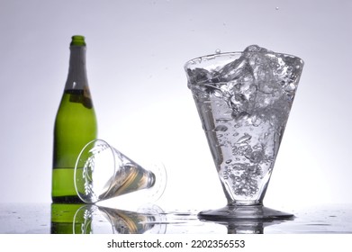 Glass of bubbling champagne and bottle - Shutterstock ID 2202356553