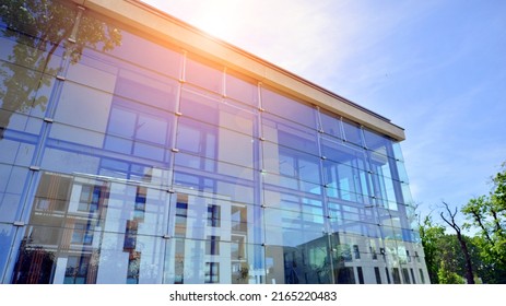 Glass building and transparent facade the building   blue sky  Structural glass wall reflecting blue sky  Abstract modern architecture fragment  Contemporary architectural background 