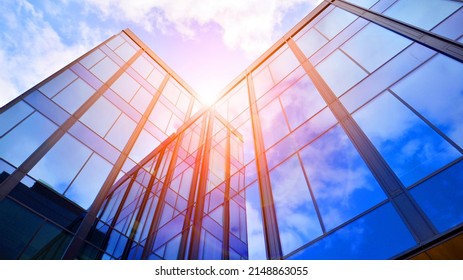 Glass buildings with cloudy blue sky background.  Perspective wide angle view to steel light blue background of glass.  Commercial modern city of future. Business concept of successful  architecture. - Shutterstock ID 2148863055
