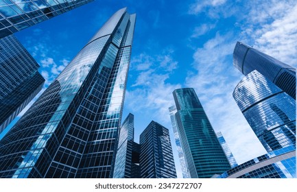 glass buildings with cloudy blue sky background - Shutterstock ID 2347272707