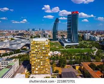 Glass Buildings In Europe City Life. Aerial View Of Modern Architecture Of Office Buildings In New City Districts. Night City Lights. The Drone Shoots At Three Towers. Milan, Italy, September 2022