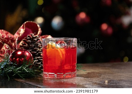glass of campari red negroni drink in Christmas atmosphere on the pub counter