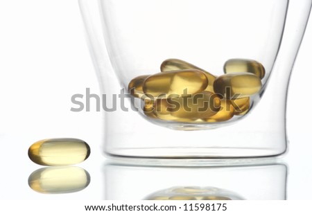 glass capsule fishoil isolated reflection yellow white medicine
