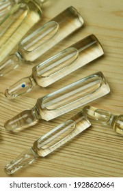 Glass capsules on a wooden surface. Healthy lifestyle concept.