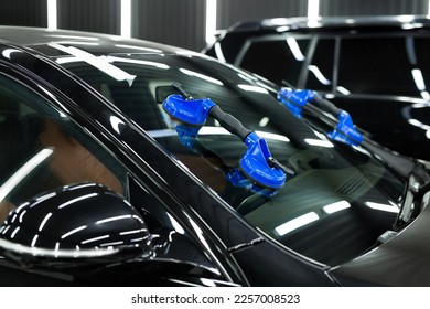 Glass of the car is a close-up in the room, removed with the help of professional suction cups. The process of car repair - Shutterstock ID 2257008523