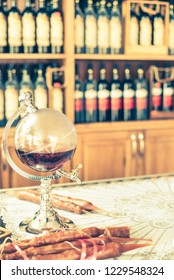 Glass Carafe In The Form Of The Globe With Brandy On The Counter Of A Liquor Store. 